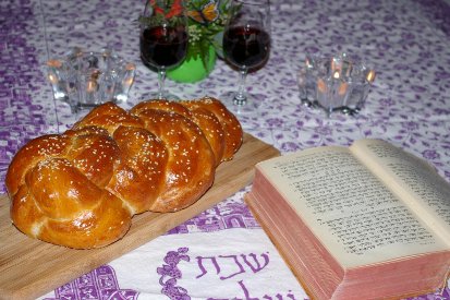 Shabbat Table with Challah, Torah, Candles and Wine